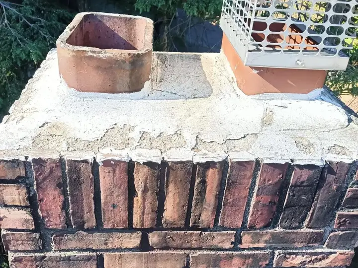 Brick chimney with a newly poured concrete crown