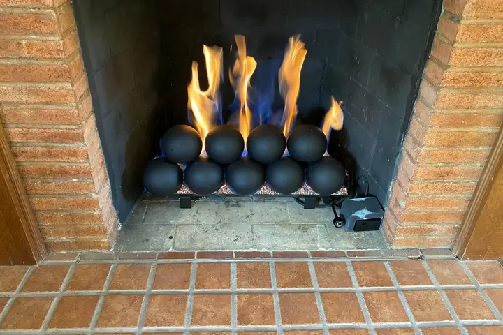 Repaired fireplace burning with ceramic fire balls
